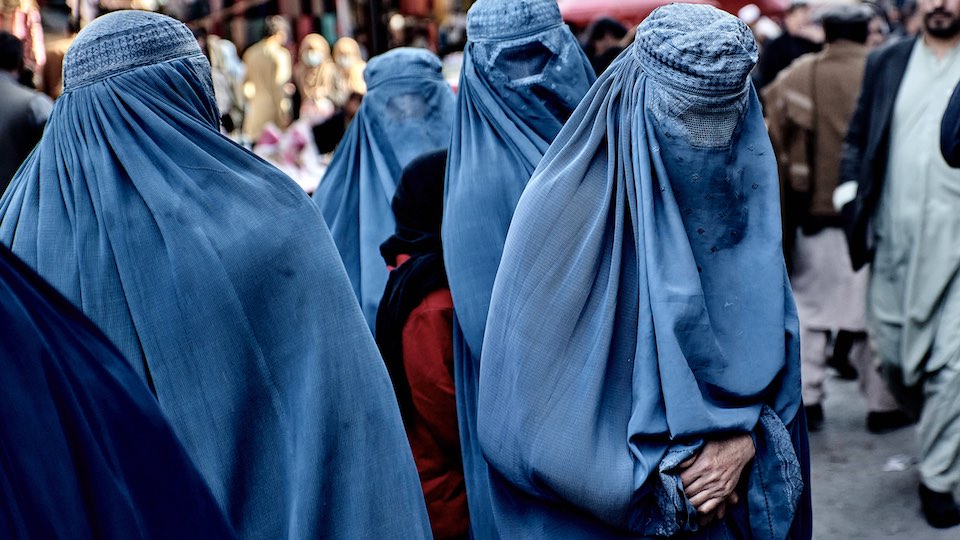 Veiled women at a market in Kabul