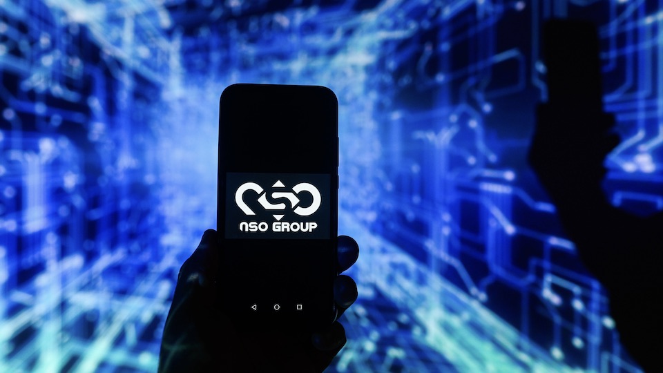 NSO logo on a smartphone against a blue background