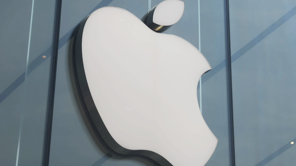 Large Apple logo on the facade of a glass building