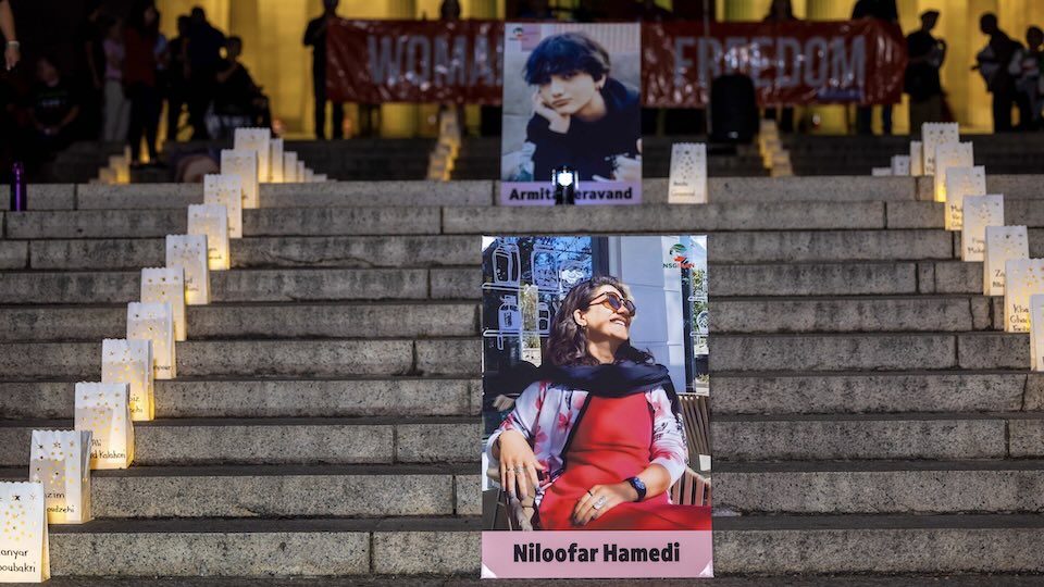 Photos of the journalists placed on stairs outside a building